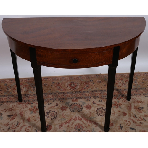 450 - A WALNUT AND EBONISED SIDE TABLE of demi lune outline with frieze drawer on square tapering legs wit... 