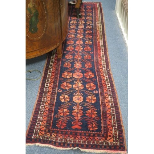 559 - A BIDJAR WOOL RUNNER the indigo and light pink ground with central panel filled with stylised flower... 