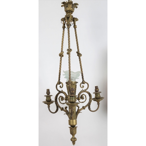 783 - A 19TH CENTURY BRASS FOUR LIGHT CHANDELIER the leaf cast and reeded central column with frosted glas... 