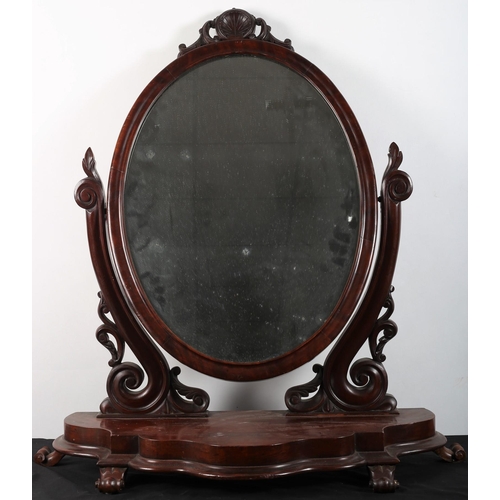 748 - A 19TH CENTURY MAHOGANY CRUTCH FRAME MIRROR the oval plate within a moulded frame raised on pierced ... 