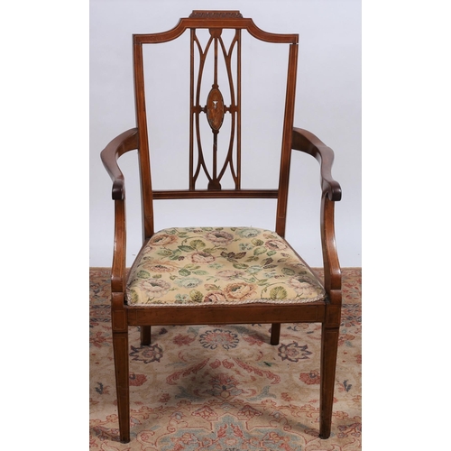 667 - A VINTAGE MAHOGANY ELBOW CHAIR the shaped top rail above a pierced vertical splat with upholstered s... 