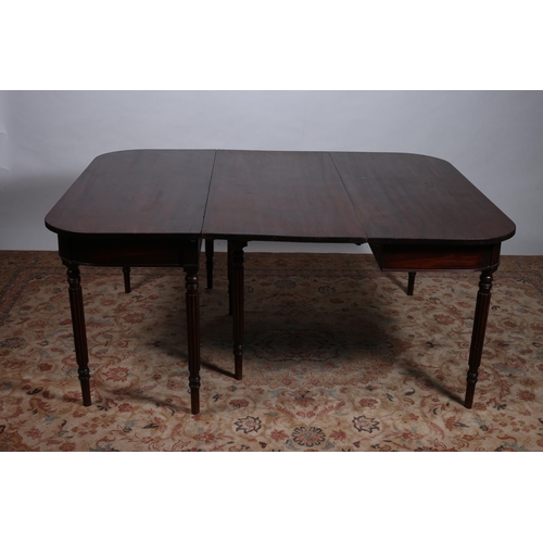 670 - A GEORGIAN MAHOGANY ECONOMY TABLE of rectangular outline with rounded ends on fluted and ring turned... 