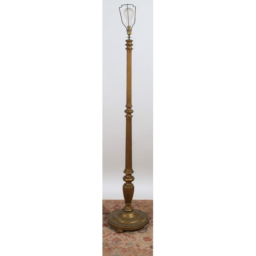 681 - A GILTWOOD STANDARD LAMP the reeded and turned column above a circular spreading foot with bun feet
... 