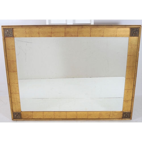 689 - A CONTINENTAL GILT FRAME MIRROR the rectangular bevelled glass plate within a moulded frame with fol... 