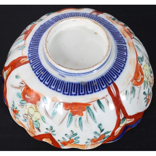 105 - AN IMARI BOWL the white, puce and blue ground with stylised flowerheads and foliage 
10cm (h) x 25cm... 