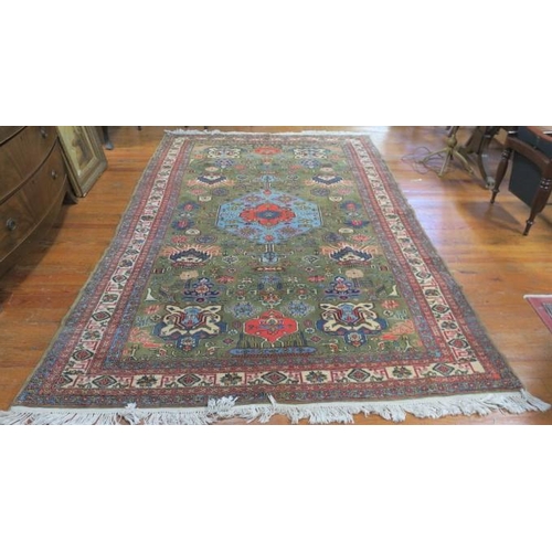 168 - AN ORIENTAL WOOL RUG the light green and beige ground with central panel filled with palmettes, styl... 