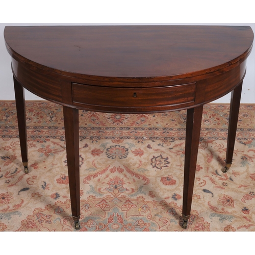 208 - A 19TH CENTURY MAHOGANY FOLDOVER SUPPER TABLE of demi lune outline the shaped top above a moulded fr... 