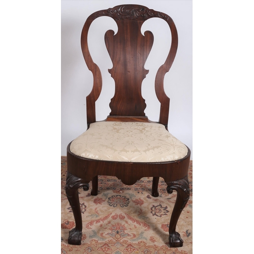 214 - A GEORGE III IRISH MAHOGANY SIDE CHAIR the carved top rail above a solid vase shaped splat with upho... 