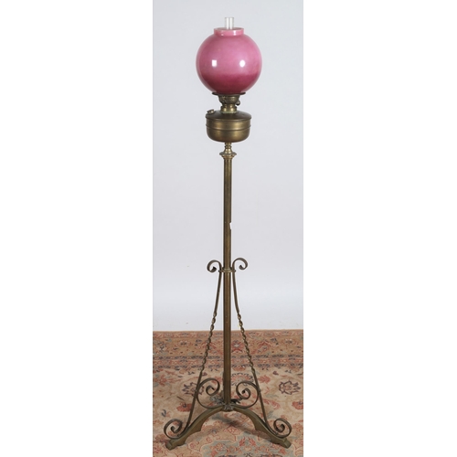 220 - A 19TH CENTURY BRASS FLOOR STANDARD OIL LAMP the opaline and lavender globe above a reservoir raised... 