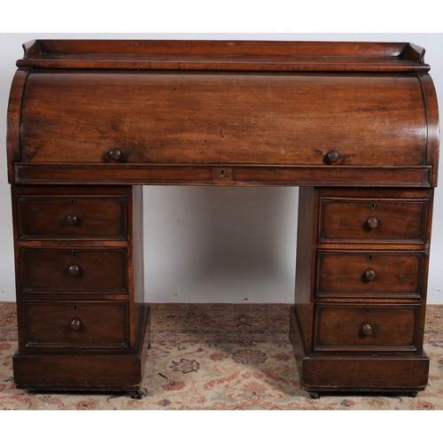 239 - A 19TH CENTURY MAHOGANY CYLINDER FRONT DESK the rectangular top with moulded gallery above a cylinde... 