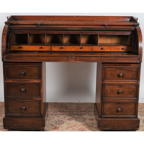 239 - A 19TH CENTURY MAHOGANY CYLINDER FRONT DESK the rectangular top with moulded gallery above a cylinde... 