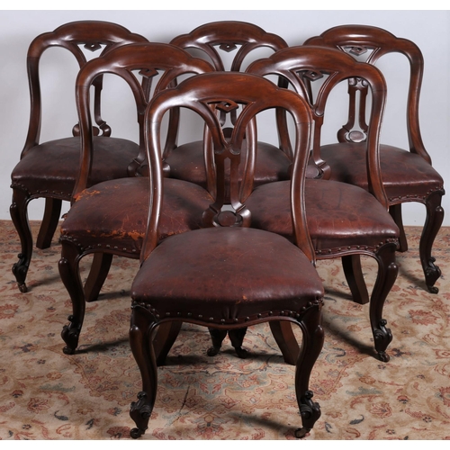 241 - A GOOD SET OF SIX 19TH CENTURY WALNUT DINING CHAIRS each with an arched top rail above a pierced car... 