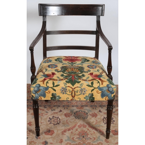 254 - A REGENCY MAHOGANY ELBOW CHAIR the shaped top rail and splats with upholstered seat on turned legs t... 