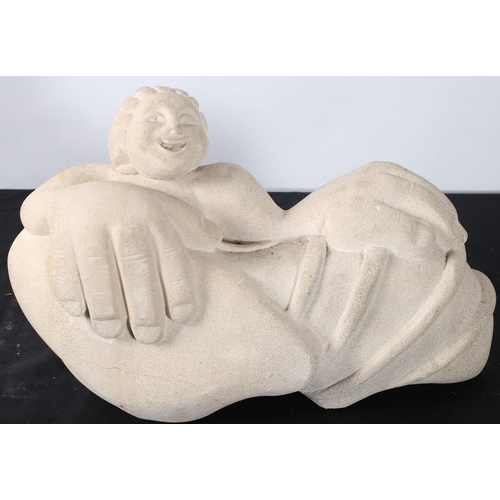 273 - A COMPOSITION STONE SCULPTURE modelled as a figure shown seated in a shell 
23cm (h) x 55cm (w)