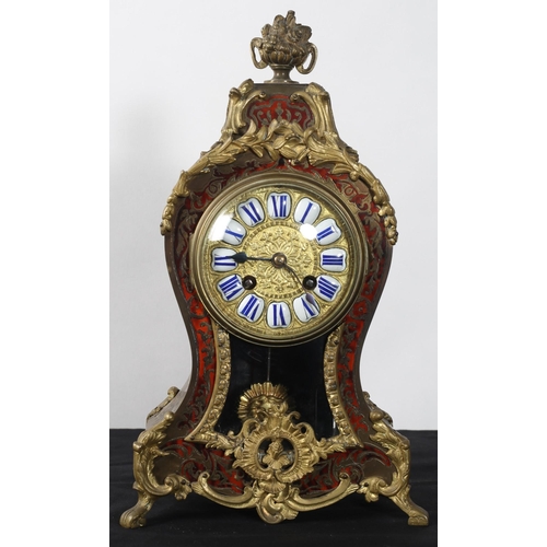 278 - A 19TH CENTURY FRENCH RED BOULLE AND BRASS INLAID MANTLE CLOCK the shaped case surmounted by a flowe... 