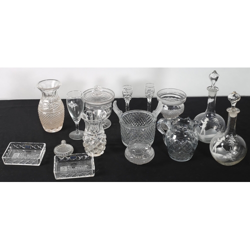 280 - A COLLECTION OF GLASSWARE to include an early cut glass piggin, cut glass vases, jugs, etc. 
On two ... 