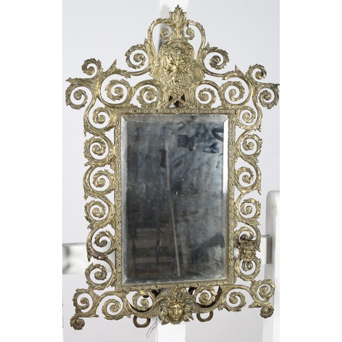 314 - A VINTAGE BRASS FRAME MIRROR the rectangular bevelled glass plate within a pierced foliate frame wit... 