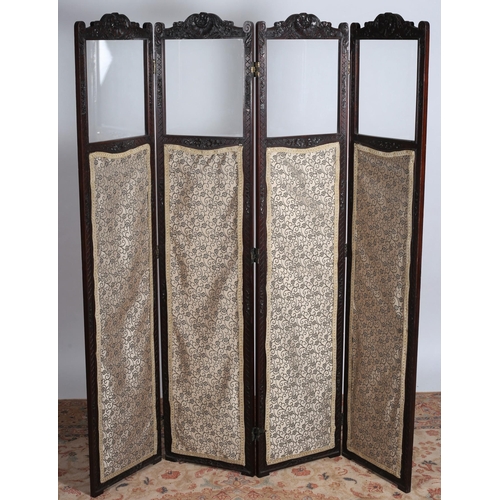 32 - A VINTAGE CARVED MAHOGANY AND UPHOLSTERED FOUR FOLD SCREEN with glazed panels on moulded base 
170cm... 