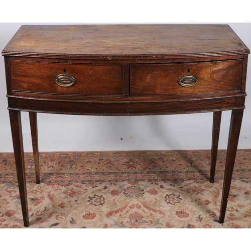 345 - A GEORGIAN MAHOGANY SIDE TABLE of rectangular bowed outline the shaped top above two deep drawers wi... 