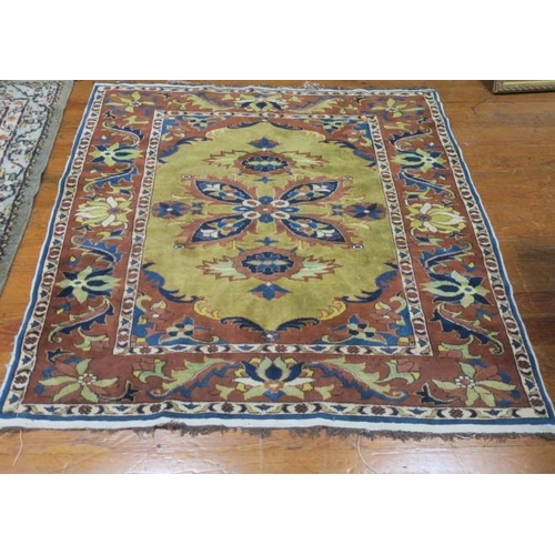 405 - AN ORIENTAL WOOL RUG the mustard and light brown ground with central panel filled with stylised flow... 