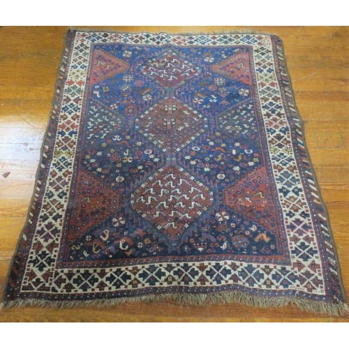 407 - AN ORIENTAL WOOL RUG the indigo and light pink ground with central panel filled with stylised flower... 