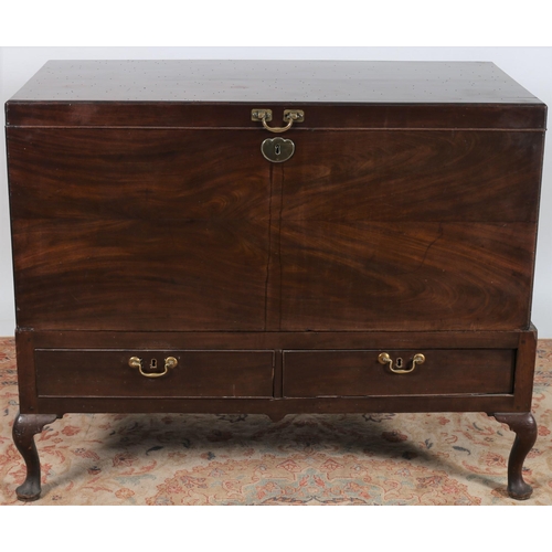 430 - A GEORGIAN MAHOGANY TRUNK ON STAND of rectangular outline the hinged lid flanked by brass carrying h... 