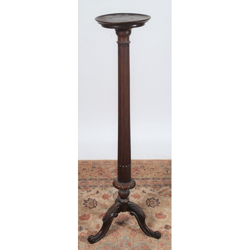 437 - A 19TH CENTURY MAHOGANY TORCHERE the circular dished top above a fluted column on carved tripod supp... 