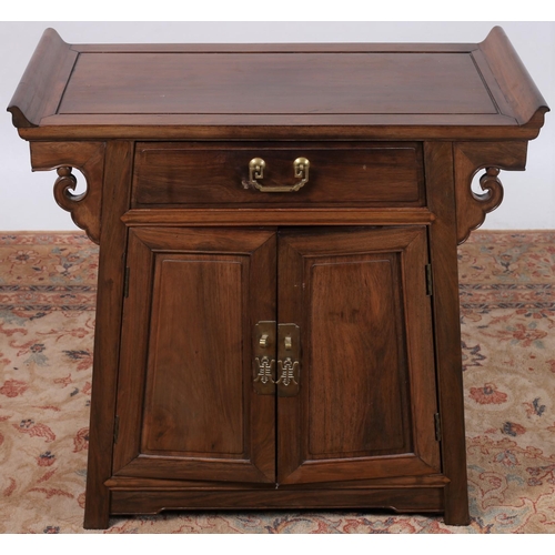 440 - AN ORIENTAL HARDWOOD SIDE CABINET of rectangular outline the shaped top with scroll ends above a fri... 