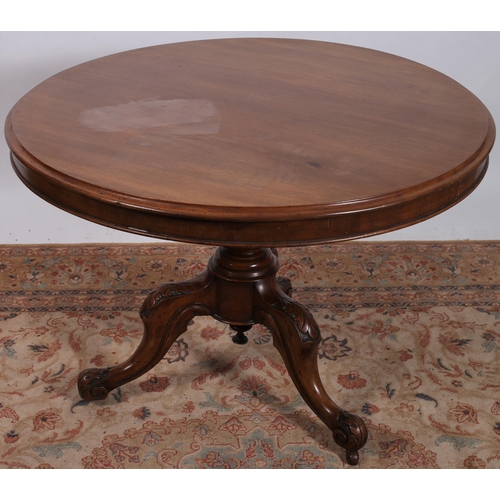 460 - A 19TH CENTURY MAHOGANY POD TABLE of circular outline the shaped top above a baluster column on quad... 