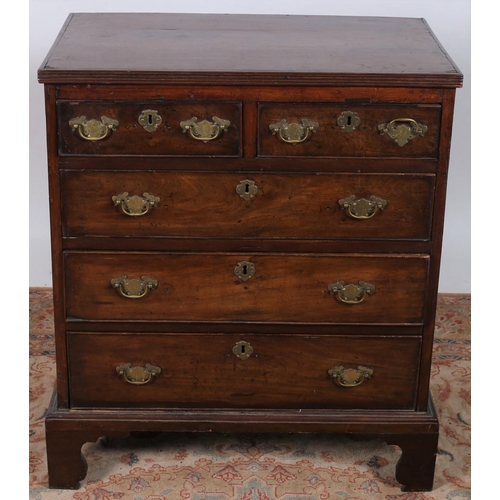 486 - A GEORGIAN MAHOGANY CHEST of rectangular outline the shaped top with reeded rim above two short and ... 