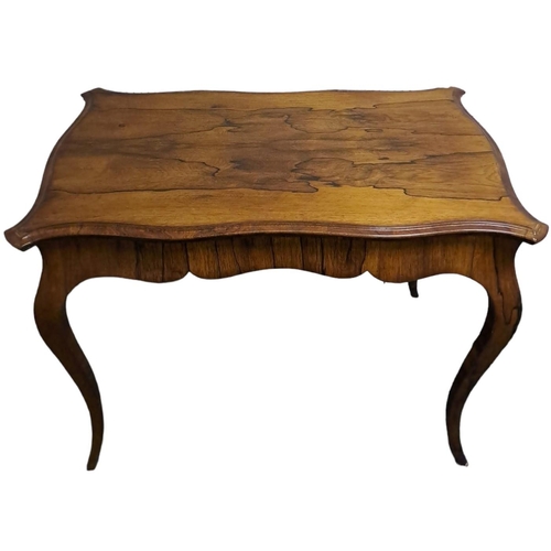 503 - A 19TH CENTURY ROSEWOOD CENTRE TABLE of serpentine outline the shaped top above a moulded apron on c... 