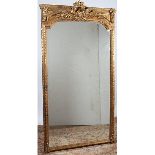 517 - A CONTINENTAL GILT FRAME MIRROR the rectangular arched bevelled glass plate within a husk and beadwo... 