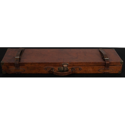 521 - A LEATHER BOUND TRAVELLING GUN CASE with brass clasps and straps 
10cm (h) x 82cm (w) x 22cm (d)