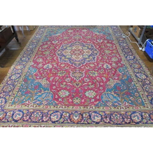 547 - AN ORIENTAL WOOL RUG the multicolour ground with central panel filled with flowerheads and foliage w... 