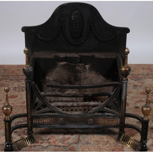 562 - A CAST IRON AND BRASS MOUNTED DOG GRATE the rectangular arched back fire hung with laurel wreath swa... 