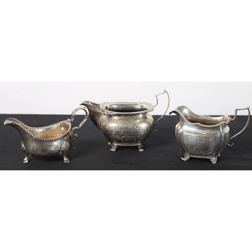 570 - A SILVER SAUCE BOAT, a silver bright cut cream jug Dublin 1828, a silver bright cut cream jug Dublin... 