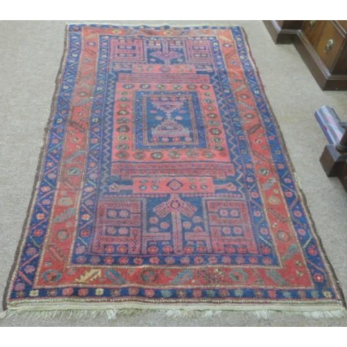 616 - AN ORIENTAL WOOL RUG the light pink and indigo ground with central panel filled with stylised flower... 