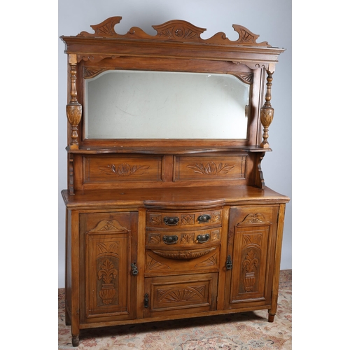 622 - AN EDWARDIAN CARVED MAHOGANY SIDEBOARD the superstructure with bevelled glass mirror above a serpent... 