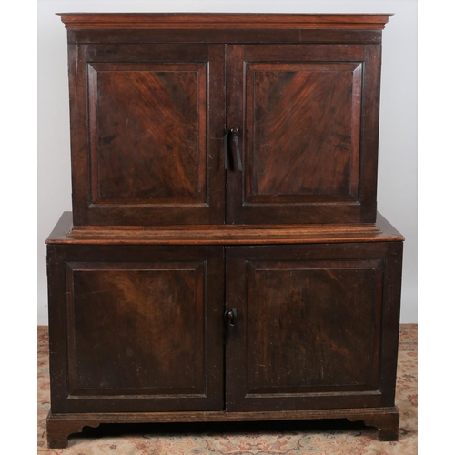 638 - A GEORGIAN MAHOGANY CUPBOARD the moulded cornice above a pair of panelled doors containing a shelf r... 