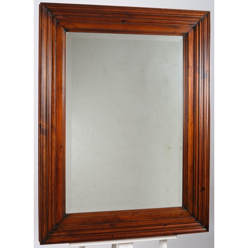 647 - A CHERRYWOOD FRAMED MIRROR the rectangular bevelled glass plate within a moulded frame 
124cm (h) x ... 