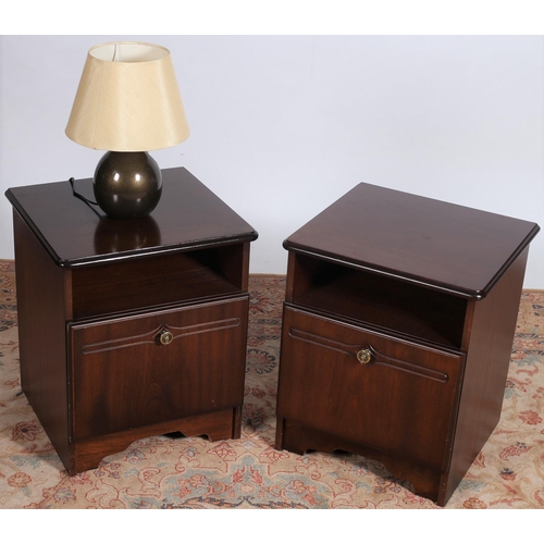 65 - A PAIR OF MAHOGANY BEDSIDE PEDESTALS each of rectangular outline the shaped top's above an open comp... 