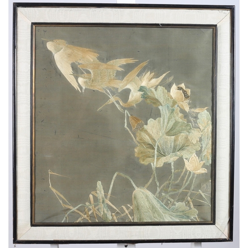 651 - AN ORIENTAL SILK NEEDLEWORK PICTURE depicting birds amongst foliage 
63cm (h) x 56cm (w)