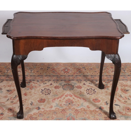 68 - A GEORGE III MAHOGANY IRISH SILVER TABLE of serpentine outline the shaped top with moulded rim flank... 