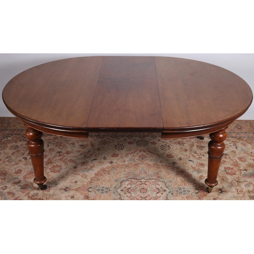 73 - A 19TH CENTURY MAHOGANY TELESCOPIC DINING ROOM TABLE of rectangular bowed outline the shaped top wit... 