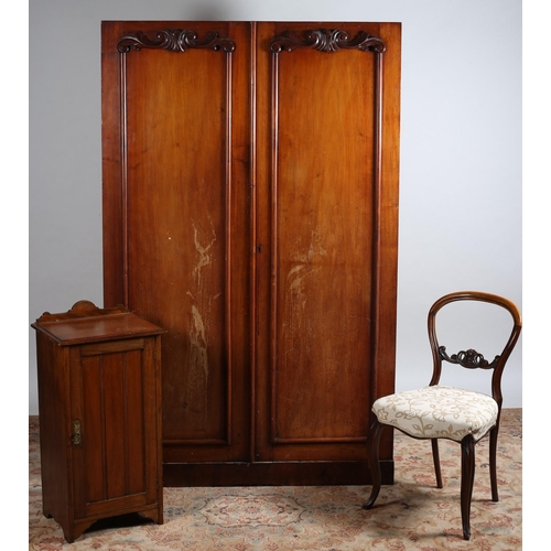 763 - A 19TH CENTURY MAHOGANY TWO DOOR WARDROBE the panelled doors with applied carving containing slide t... 