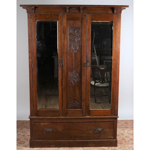 764 - A TWO PIECE ART NOUVEAU OAK BEDROOM SUITE comprising a dressing table the superstructure with bevell... 