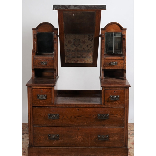 764 - A TWO PIECE ART NOUVEAU OAK BEDROOM SUITE comprising a dressing table the superstructure with bevell... 