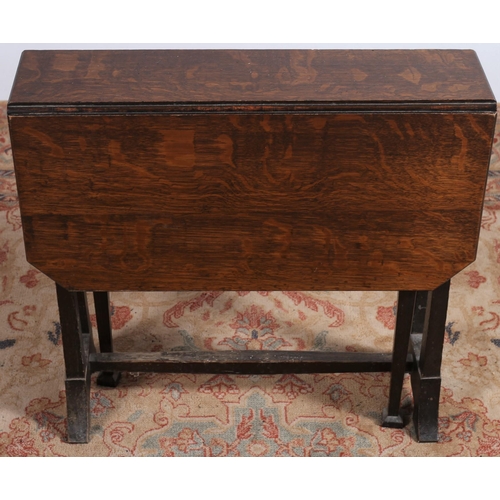 84 - A VINTAGE OAK SUTHERLAND TABLE the rectangular hinged top raised on dual supports and platform base ... 