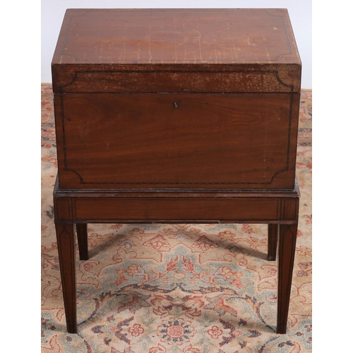 89 - A 19TH CENTURY MAHOGANY CELLARETTE the rectangular hinged lid on a moulded stand with square taperin... 