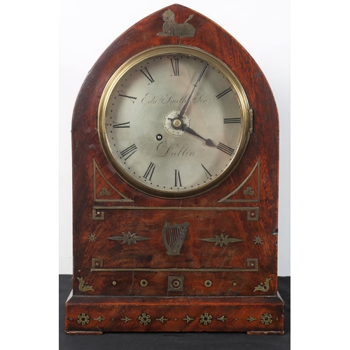 96 - A GEORGIAN IRISH ROSEWOOD AND BRASS INLAID CASED CLOCK the rectangular arched case with silvered dia... 